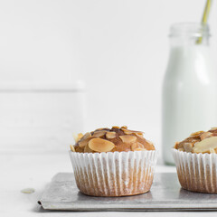 almond muffins on a silver tray, bakery style almond muffins on a white background