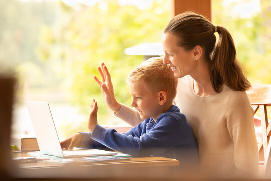 Happy Mother Child Making Video Call Using Computer At Home 