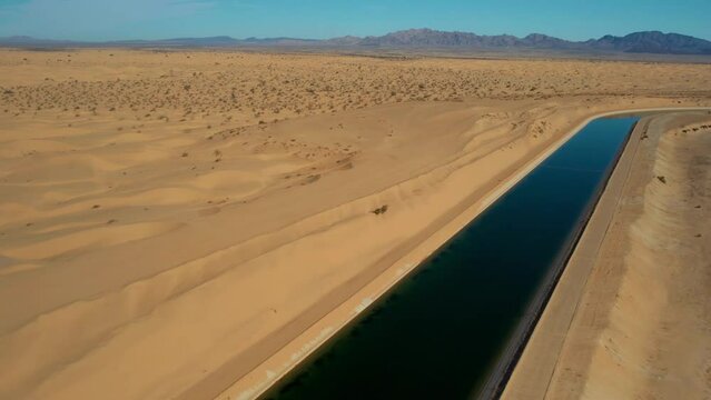 Dramatic aerial view of the all-American canal traveling through the Buttercup sand dunes in imperial county California.