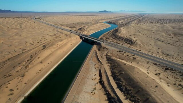 Dramatic aerial view of the all-American canal traveling through the Buttercup sand dunes in imperial county California.