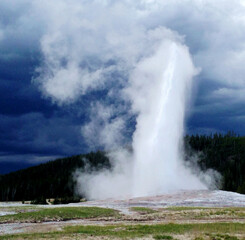 Fototapeta na wymiar Spectacular panoramic views at Old Faithful Geyser in Yellowstone National Park, Wyoming Montana. Great hiking. Summer wonderland to watch wildlife and natural landscape. Geothermal.