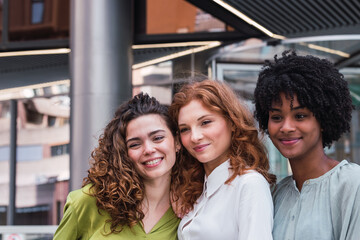 Fototapeta premium Smiling team of diverse businesspeople standing together outside office building