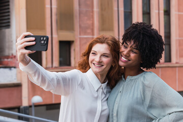 Two multicultural women friends taking a selfie