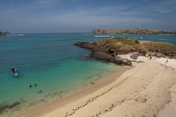 Aerial view of Tanjung Aan beach in Lombok Island, West Nusa Tenggara, Indonesia. Turquoise crystal clear water beach in tropical island. 