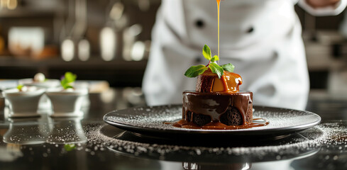 Chef garnishing chocolate dessert with caramel sauce - obrazy, fototapety, plakaty
