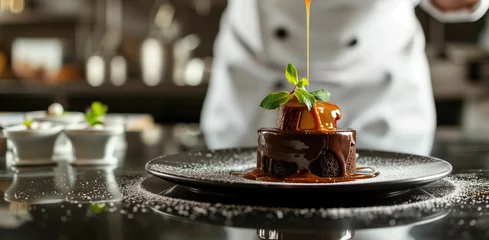 Foto op Canvas Chef garnishing chocolate dessert with caramel sauce © Artyom