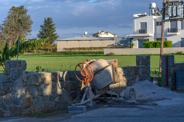 a concrete mixer stands on the street in the village 2