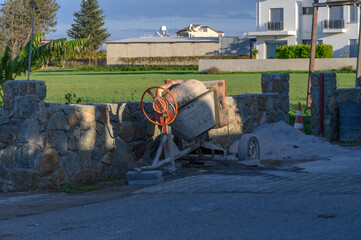 a concrete mixer stands on the street in the village 1