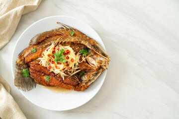Fried Sea Bass Fish with Fish Sauce and Spicy Salad
