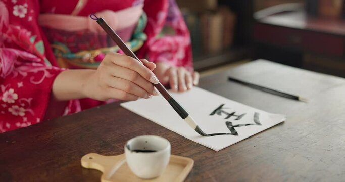 Paintbrush, ink and hands, Asian script and writing with paper, document and creativity, calligraphy and traditional text. Japanese font, writer with black paint and person at desk with art and tools