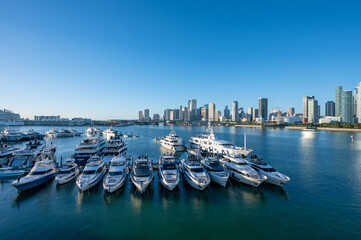 Yachts docked at Yacht Haven Grande marina on Jungle Island with City of Miami, Florida in...
