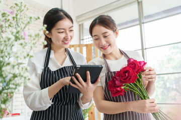 Two Asian florist Females receiving order of flowers