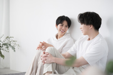 Couple relaxing in their room wearing relaxing clothes