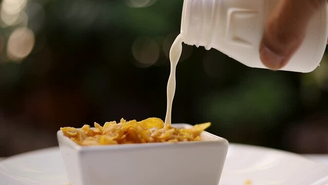 Pour cereal, cornflakes and milk into a white bowl. Healthy food
