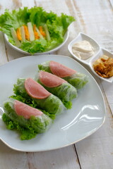 Spring rolls are a rolled appetizer or dim sum commonly found in Chinese and Asian cuisine. Raw fresh vegetable salad roll with mayonnaise.