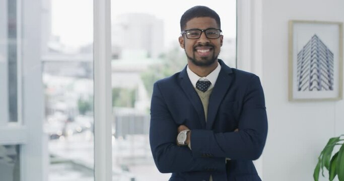 Happy, crossed arms and face of businessman in the office with glasses for vision in a classy suit. Smile, portrait and young male lawyer with positive, good and confident attitude in workplace.