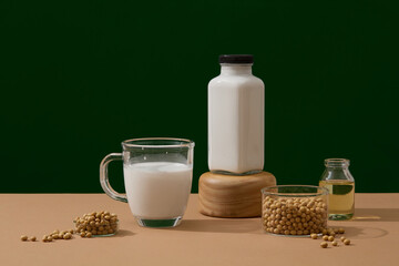 Healthy concept with soybean milk and soybean oil filled inside a glass and bottles. A bowl of...