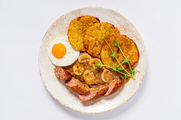 potato pancakes with sausage and fried egg