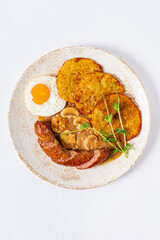 potato pancakes with sausage and fried egg