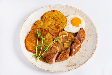 potato pancakes with sausage and fried egg