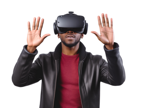 A young African-American man wearing virtual reality glasses stands with his hands raised. Isolated on a transparent background.