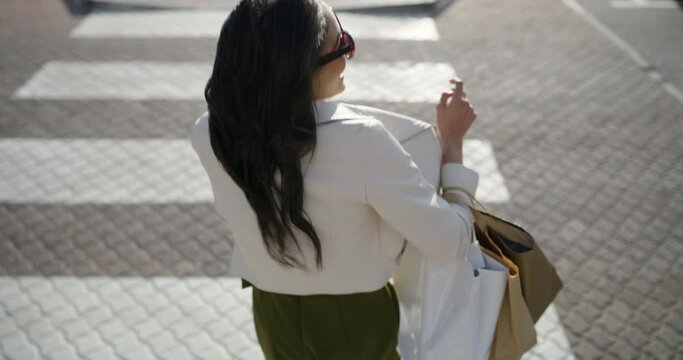 Walking, phone call and woman with shopping bags in city for sale, promotion or discount. Communication, housewife and rich female person on mobile conversation commuting in town for retail fashion.