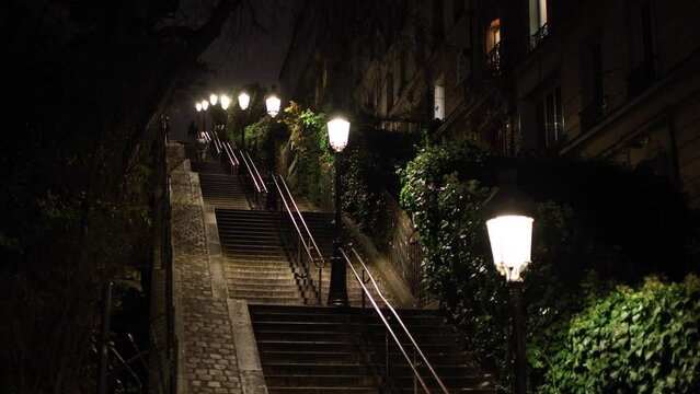 4K night video on Montmarte stairs street from Paris. Beautiful night scene showing the architecture of old times in Paris. Travel to France.