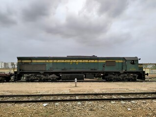 Fototapeta na wymiar Pakistan railways GMU-30 4728 engine attached with freight train is ready to Departure from Landhi Junction Karachi at 12 July 2023 along with clouds