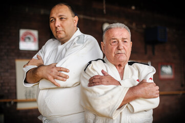 Two respected and experienced judo sensei master instructor in traditional gi kimono. A skilled...