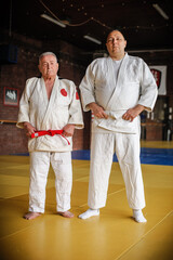 Two respected and experienced judo sensei master instructor in traditional gi kimono. A skilled...