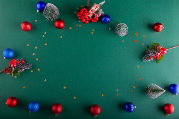 Green Christmas background with colorful balls, stars and twigs - 703703879