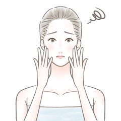 両手を顔に当て肌について困るバスタオルを巻いた女性