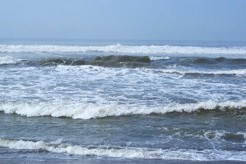 sea waves on a beach with black sand, holiday and vacation at summer