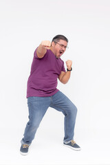 A overweight middle aged guy makes a funny looking punch. Overwhelmed with joy. Full body photo,...