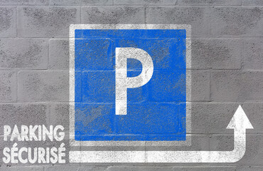 Parking, panneau indicatif fléché peint sur mur de parpaings 