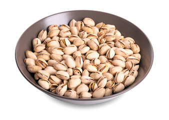 Roasted and salted pistachios in their shells, in a brown bowl. Crunchy roasted fruits of Pistacia vera, with opened shells and their seeds within. Snack food. Close-up, macro food photo.