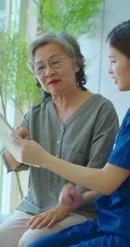 Senior woman talking with female nurse at hospital. Nurse makes an appointment with a senior woman at the hospital.
