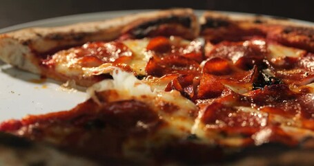 Pizza with pepperoni, mozzarella cheese, tomato sauce, olive oil and basil leaves.