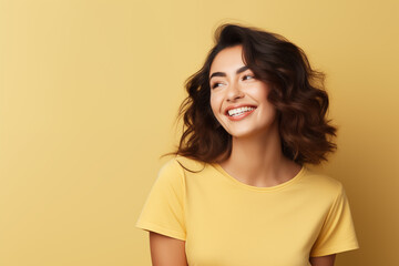 Photo of an happy woman wearing casual clothes. Portrait. Isolated on a yellow background.