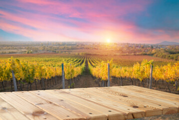 Brown wood table in autumn vineyard landscape with empty copy space on the table for product...