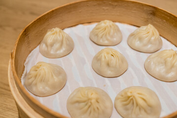 Steamed xiaolongbao served in a traditional steaming basket