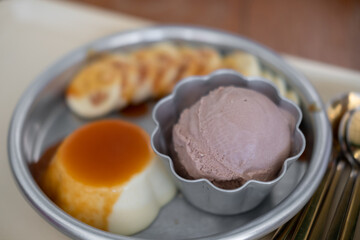 Chocolate ice cream served with pudding and sliced banana