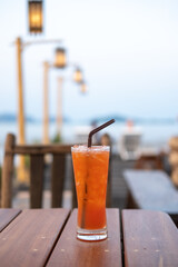 A glass of Mai Tai, a cocktail made of rum on the table with view of the beach