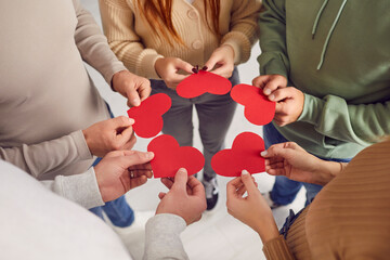 Group of friends exchanging valentines. Cropped shot of young adult people standing in circle and...