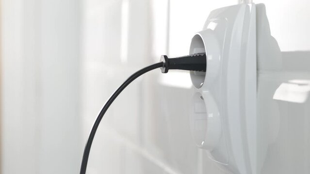 Plugging Electrical Cord in Wall European Socket, Plug in Devices, Electric Power View, Save Cost in Energy Industry Crisis
