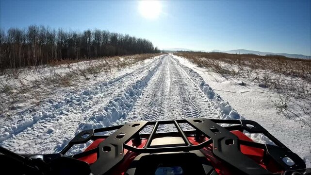 Driving an ATV off-road in winter is a point of view, POV driving an ATV. Off-road ATV adventures.