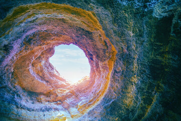 Coastal rocky seascape, hole of Benagil cave in Algarve region in Atlantic ocean, Portugal, Europe