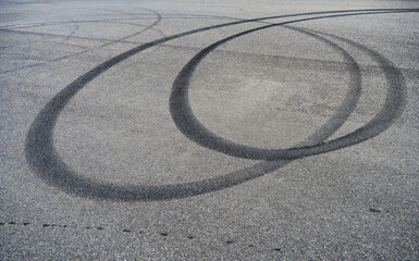 skid marks on a road surface. Circular tire marks left by drivers doing doughnuts