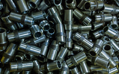 full-frame background of batch production of steel parts after turning.