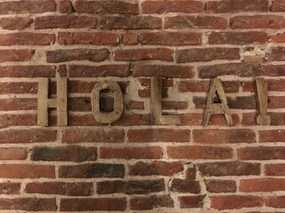 brickwall with the word hola © Anne